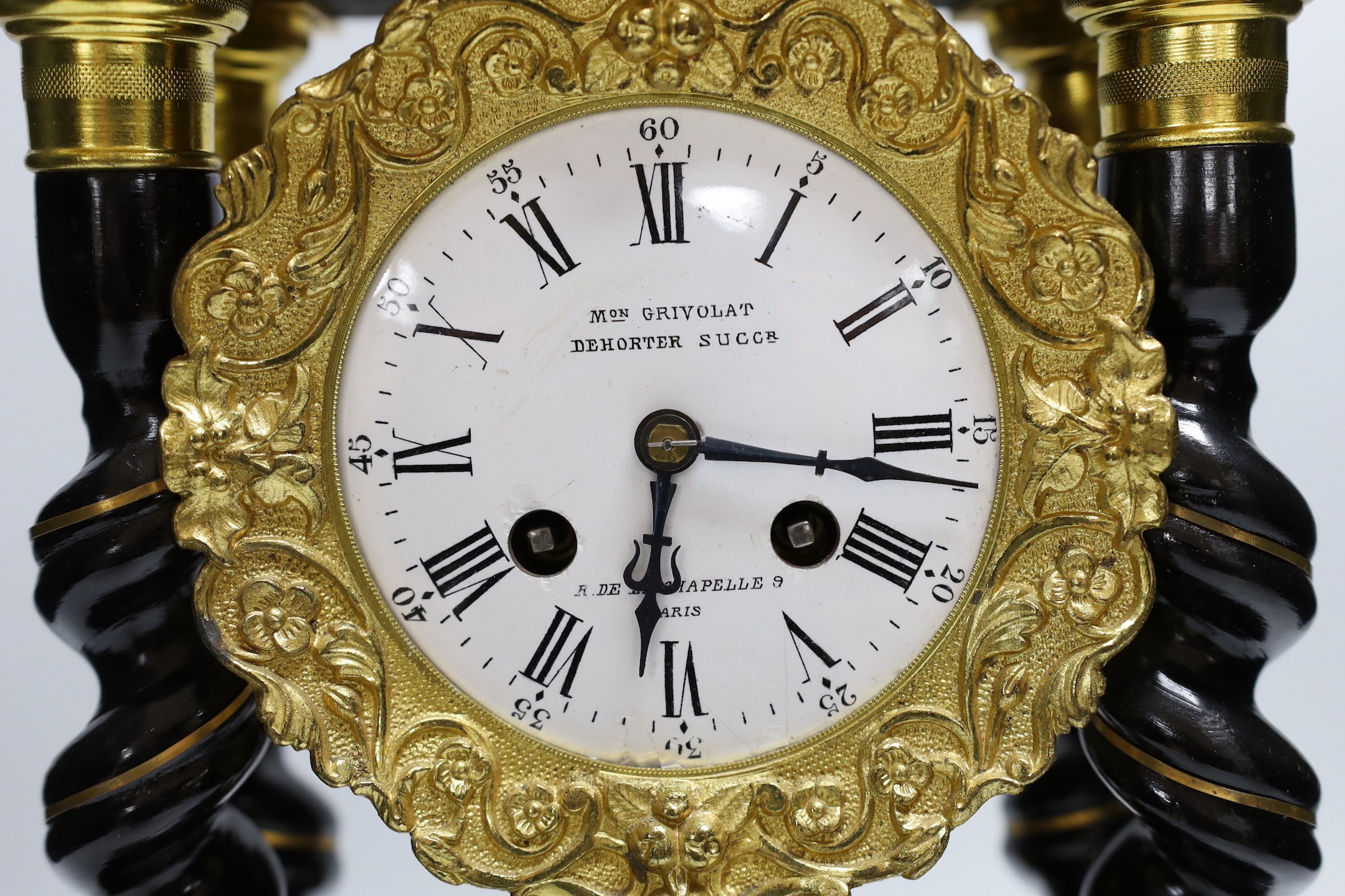 A French Napoleon III ebonised and brass inlaid portico clock. 49cm tall